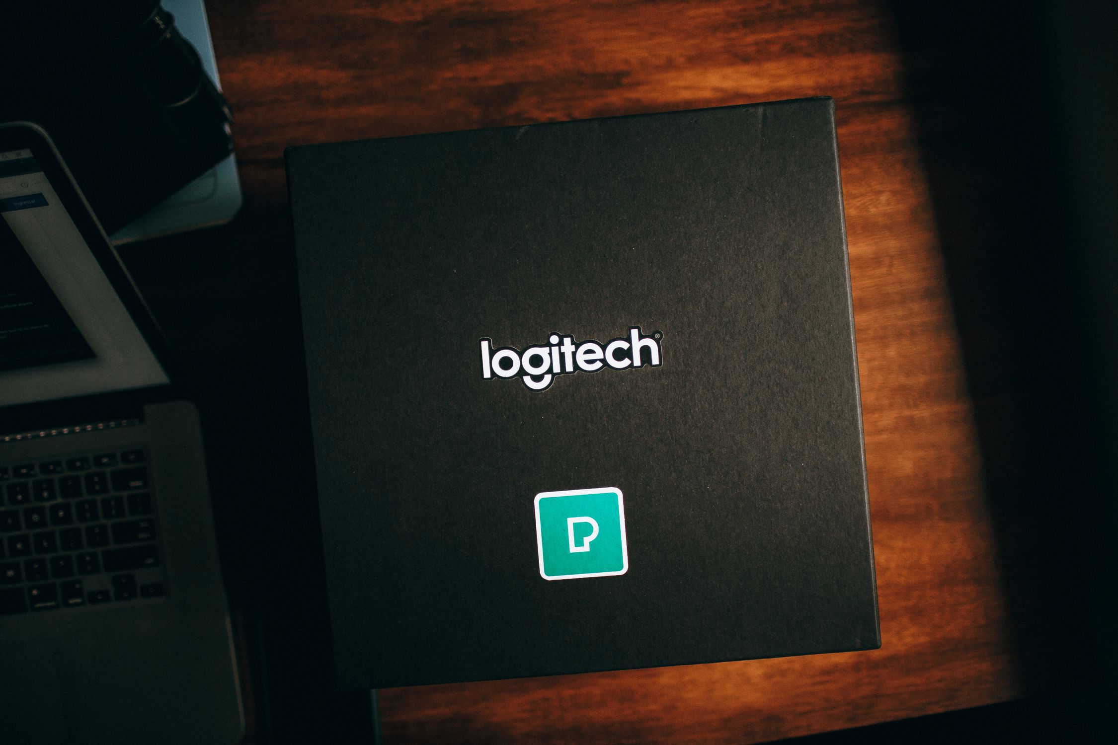 Black Logitech Box on Brown Wooden Table · Free Stock Photo