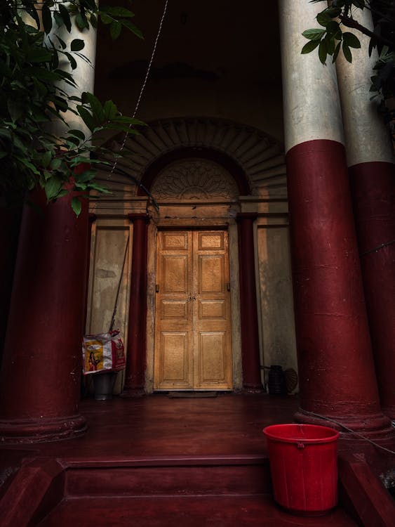 Brown Wooden Door between Columns 