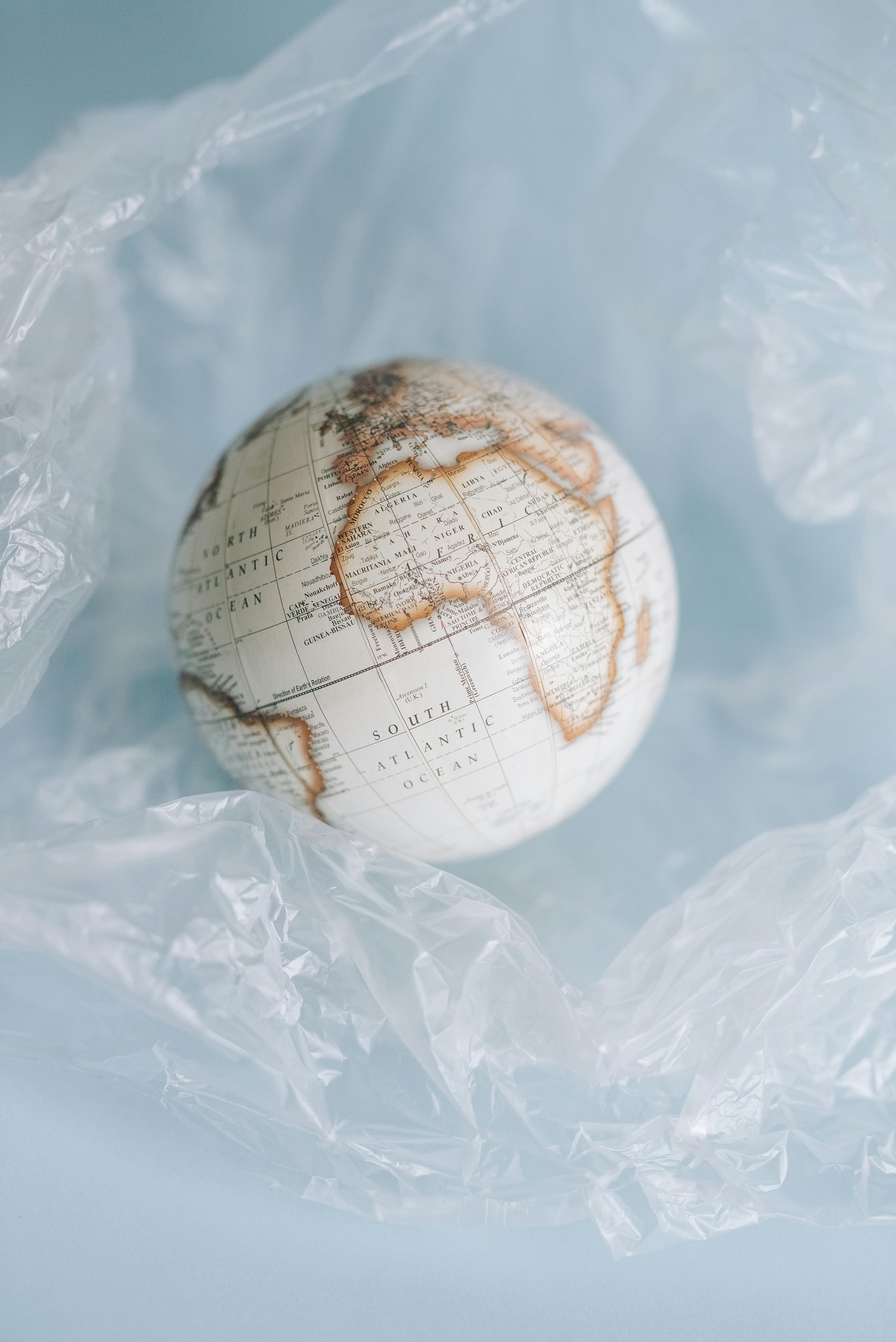 a globe in a clear crumpled plastic sheet