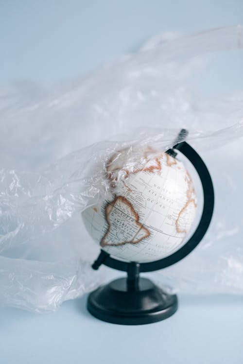 A Desk Globe Covered in a Plastic Sheet