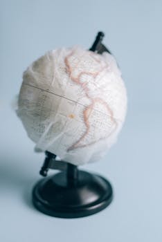 Close-up of a globe wrapped in plastic, symbolizing global environmental issues.