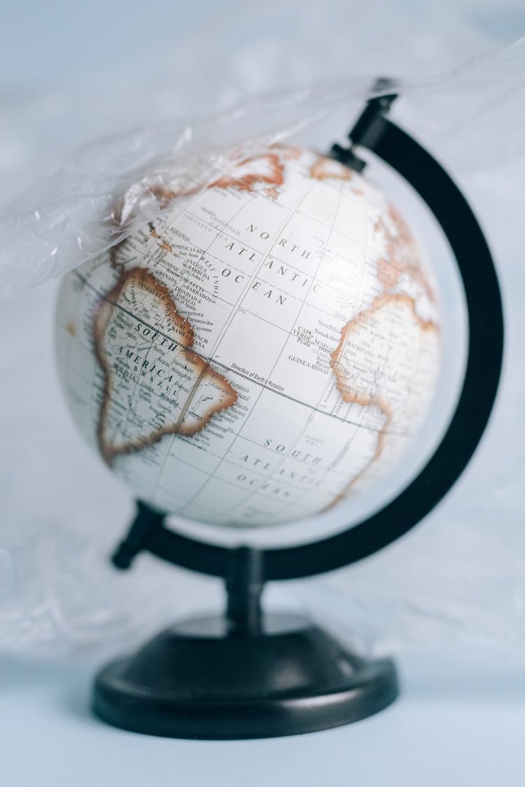 A White And Black Desk Globe Covered In A Plastic Sheet