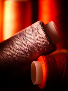 Vibrant and artistic close-up of colorful thread spools, perfect for creative projects.