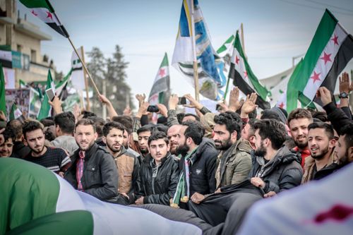 Free A large group of protesters with flags demonstrating in Idlib, Syria. Stock Photo