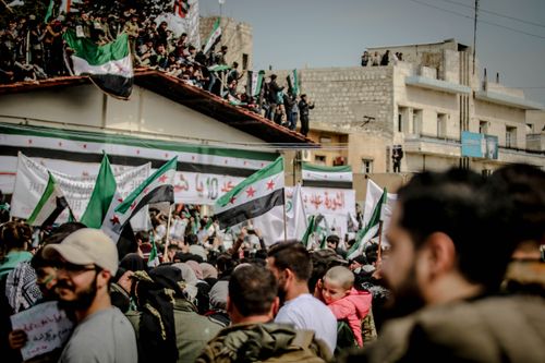 Free A vibrant protest scene in Idlib showcasing crowds with flags and signs. Stock Photo
