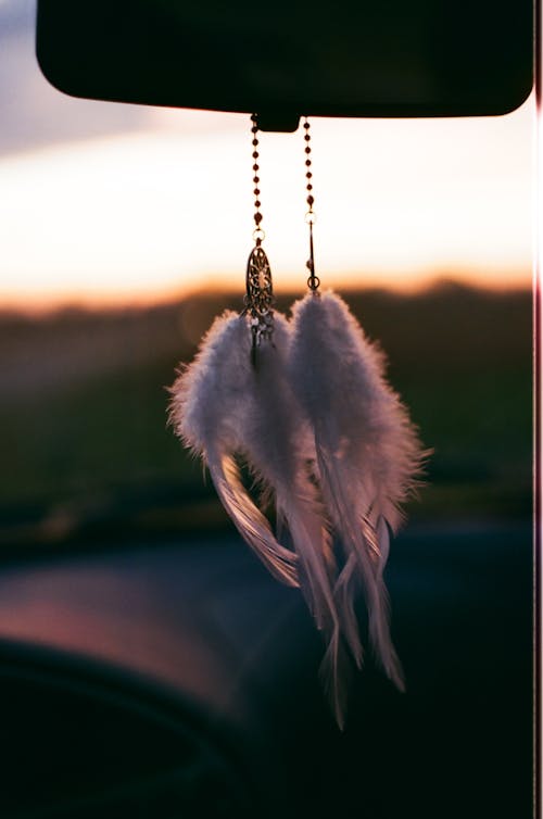 Free Photo of White Dreamcatchers Hanging on a Rear View Mirror Stock Photo
