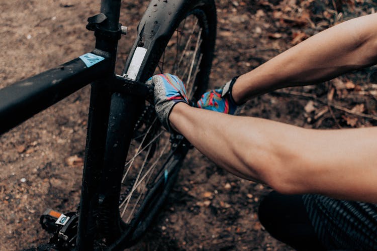 Person Repairing A Bicycle Wheel