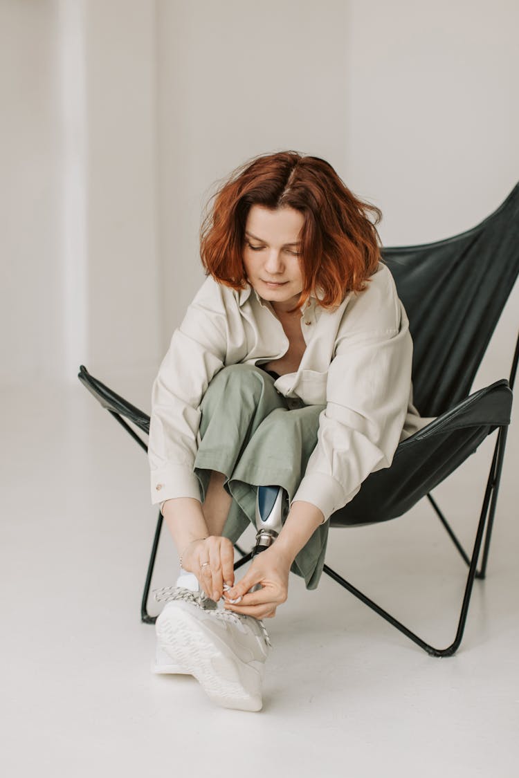 Woman Tying Shoe Laces 