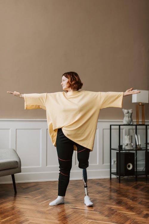 Free Woman in Yellow Shirt Extending Her Arms Stock Photo