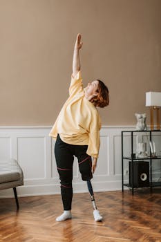 Caucasian woman with prosthetic leg stretching at home, showcasing empowerment and fitness.