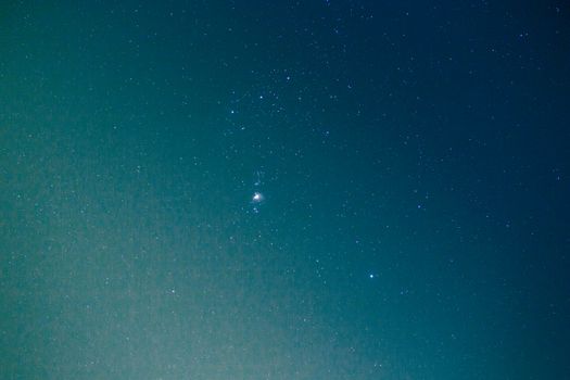 A stunning view of the Orion constellation amidst a starry night sky.