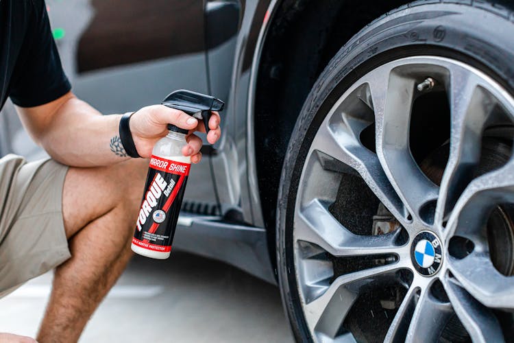 Man Hand Spraying A Car Wheel