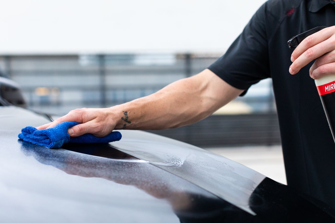 Profesional limpiando y acabando la pintura de un coche