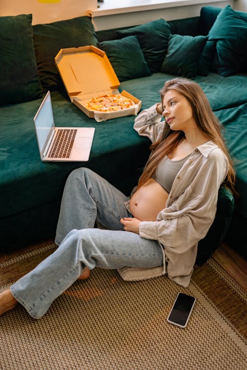 Pregnant Woman looking at Laptop 