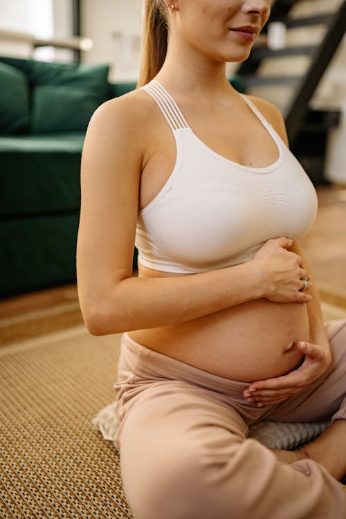 Free A Pregnant Woman Touching Her Belly Stock Photo