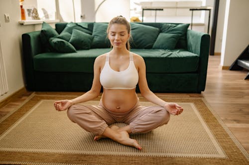 Free A Pregnant Woman Doing Meditation Stock Photo