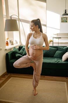 Expectant mother practicing yoga in a cozy living room setting.