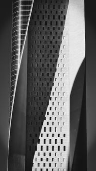 Black and white photo of a tall, modern skyscraper with a unique facade.