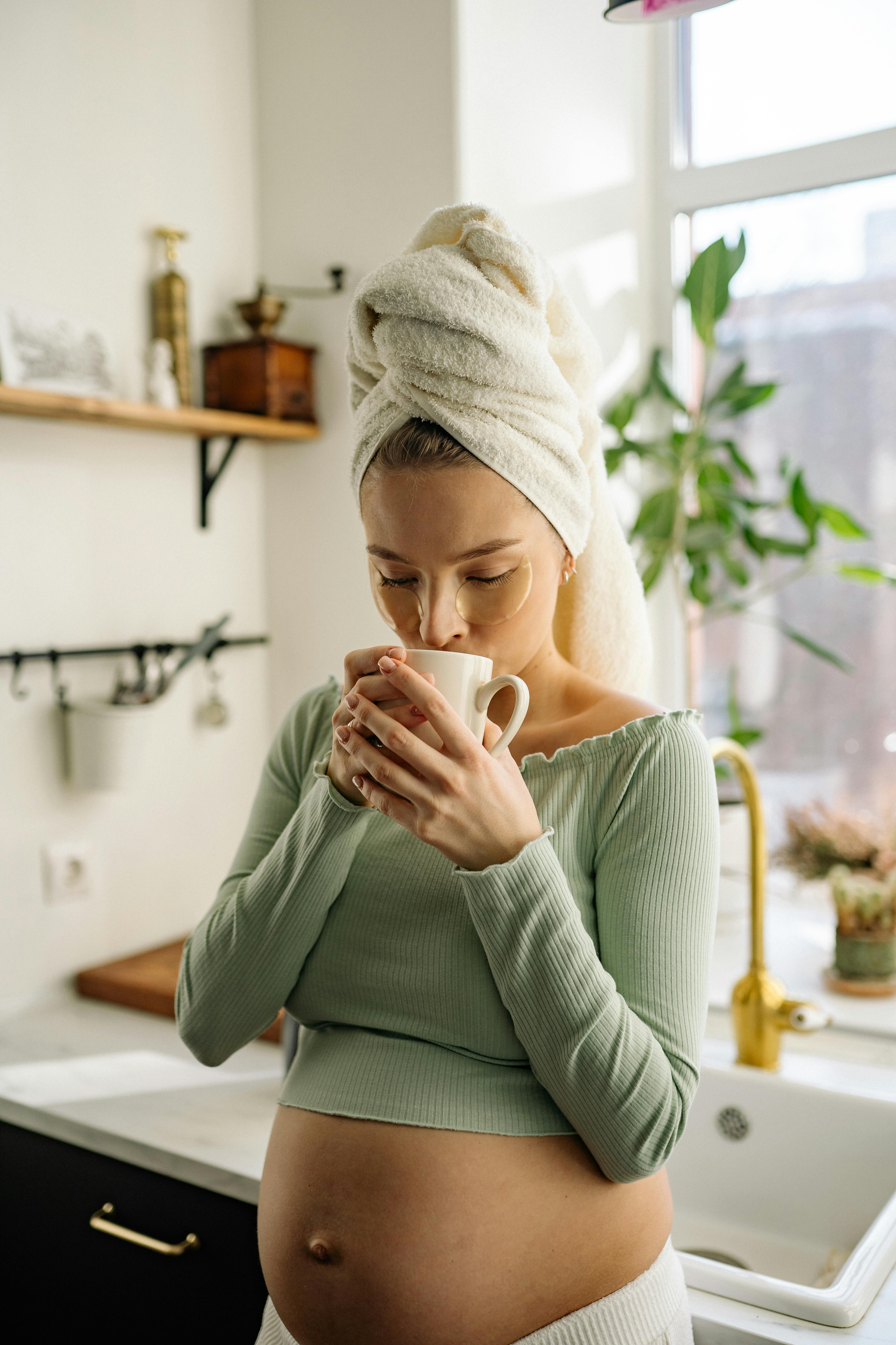 a pregnant woman having a hot drink