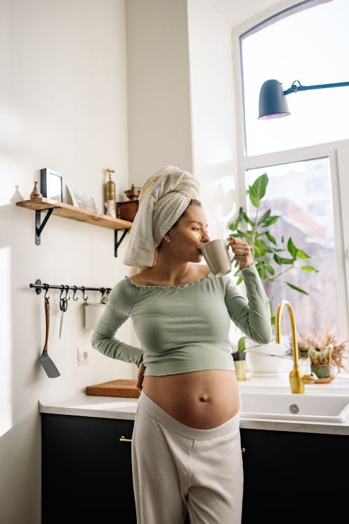 Free A Pregnant Woman Having a Cup of Hot Drink Stock Photo