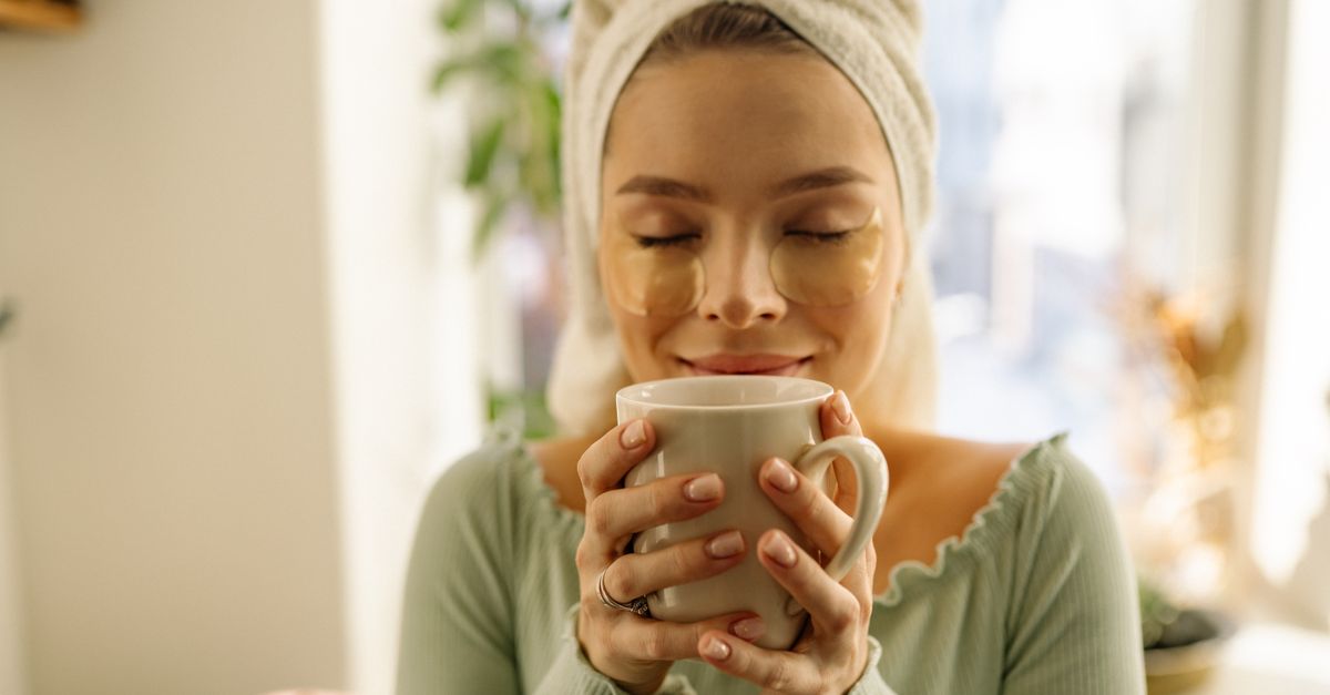A woman with eye patches enjoys a warm cup of tea, capturing a moment of relaxation. - Evidence evidence guide for green tea eye fatigue randomized trial