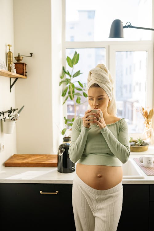 Free Pregnant Woman drinking Hot Beverage  Stock Photo