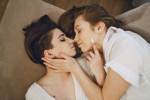 Free A loving same-sex couple sharing an intimate moment while embracing at home. Stock Photo