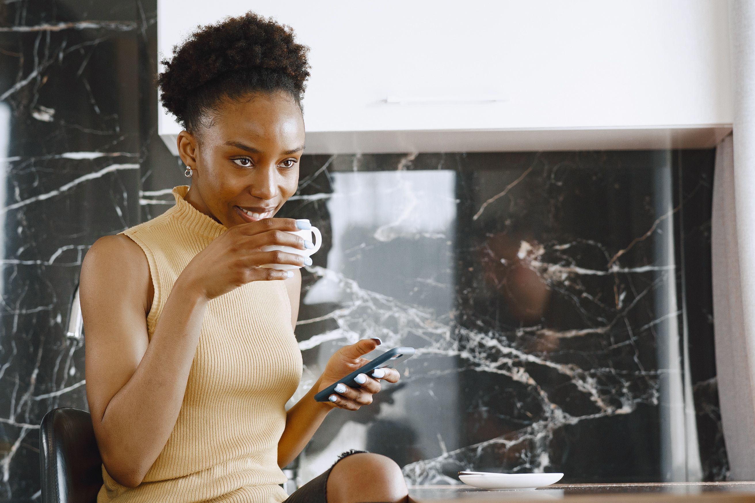 Free A Woman Drinking a Cup of Coffee Stock Photo
