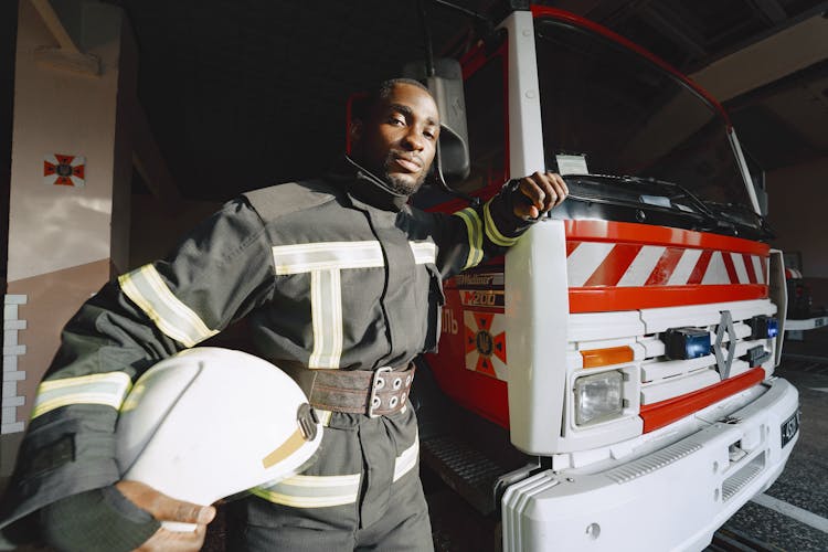 Firefighter Posing With His Truck