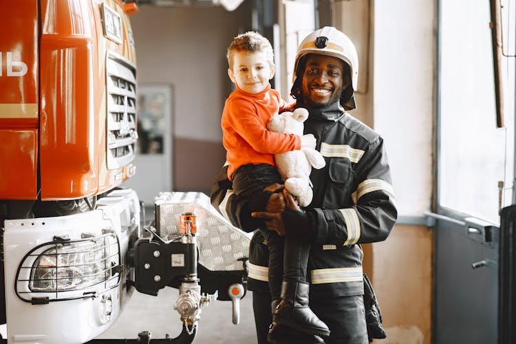 Fireman Carrying A Cute Boy 