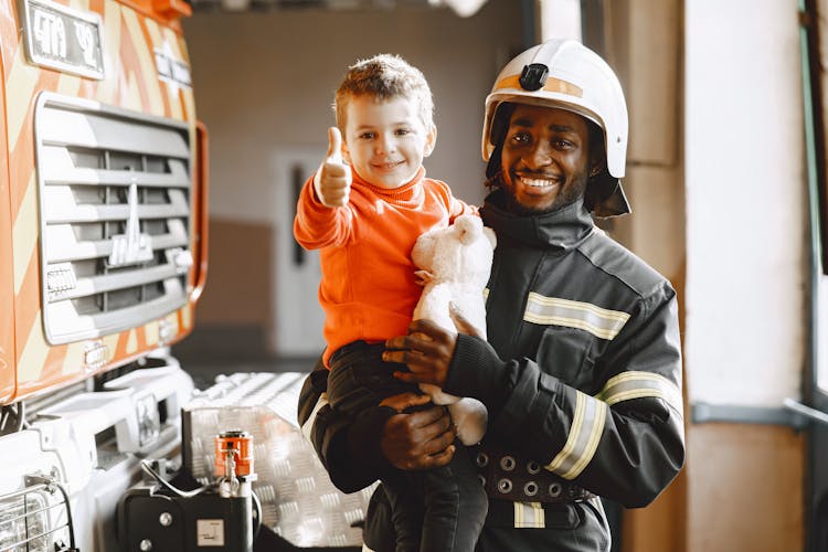 Fireman Carrying A Cute Boy 