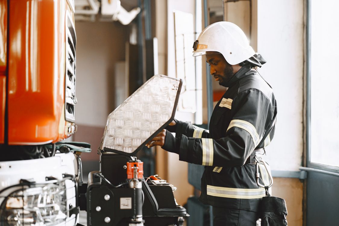 Fire Mechanic Fireman checking the Truck's Engine · Free Stock Photo