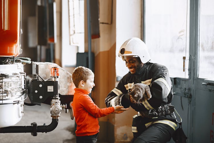 A Fireman Rescuing A Cat For The Boy