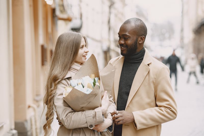 Woman holding bouquet of flowers beside a man