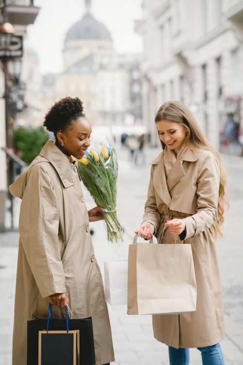 Free Two women shopping outdoors, enjoying a winter day. Stock Photo
