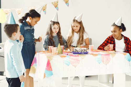 Free Kids Standing Near the Table Stock Photo