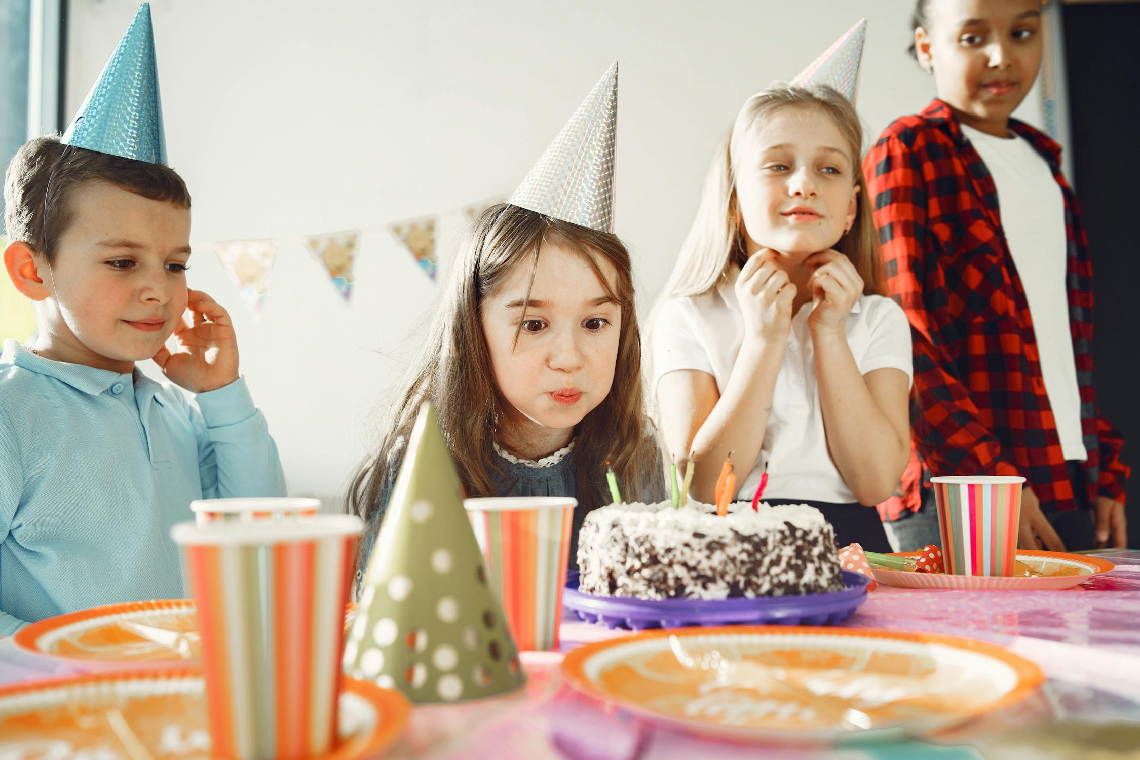 kids at birthday arty wearing hats