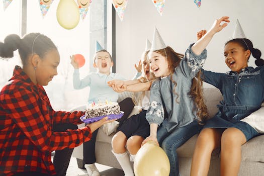 Excited children celebrating a birthday with cake and party hats, capturing joyful moments.
