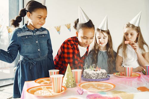 Birthday Celebrant blowing the Candles on her Cake 