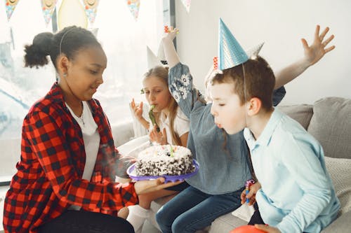 Boy blowing candles on the Cake 