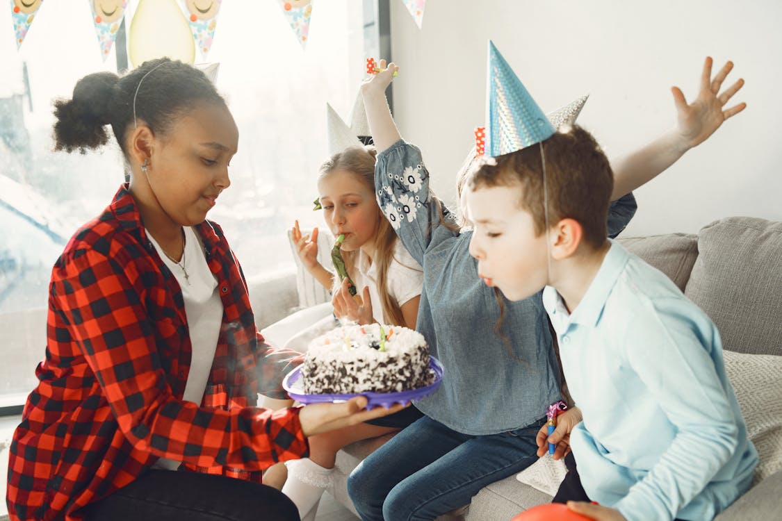 Boy blowing candles on the Cake 