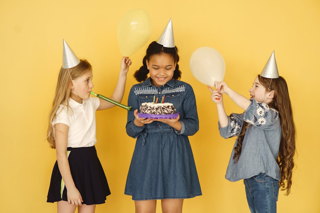 Free Kids Holding Balloons and Cake Stock Photo