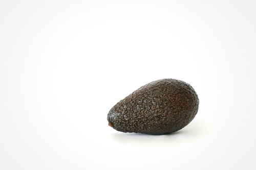 Free Close-up of a ripe avocado against a clean white background, ideal for health and food themes. Stock Photo