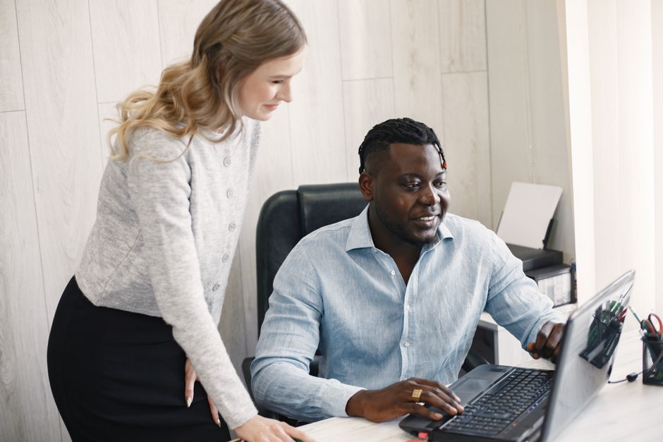 A diverse team collaborating in a modern office setting, focusing on a project.