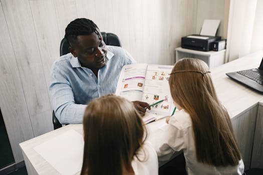 A teacher guiding students through a textbook during a home schooling session.