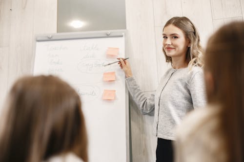 Free A Woman Discussing in Front of the Whiteboard Stock Photo