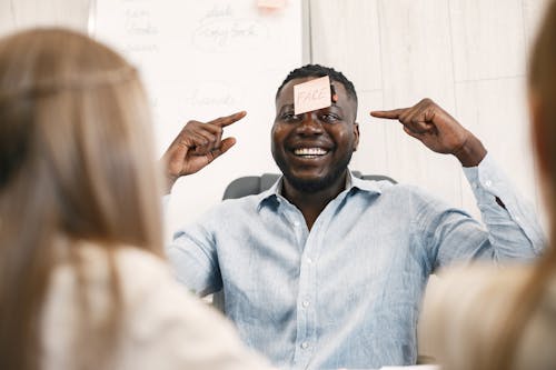 Happy Teacher with Sticky Note on His Forehead