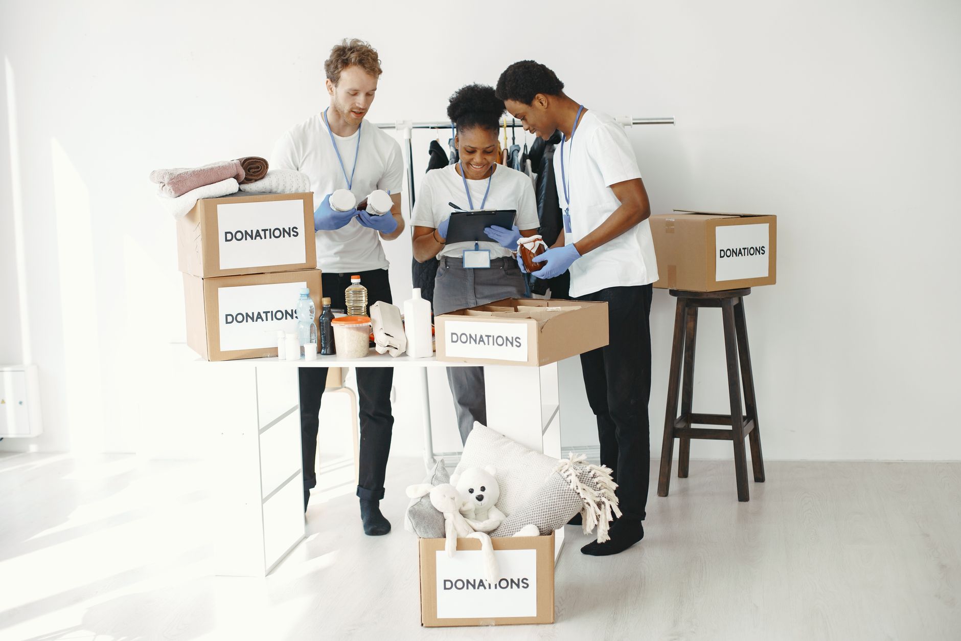 Volunteers organising donation boxes filled with essentials