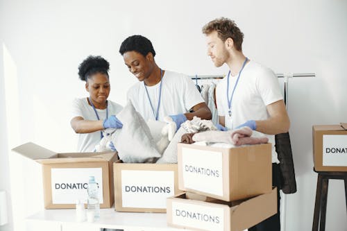 Free Volunteers packing up Donations  Stock Photo
