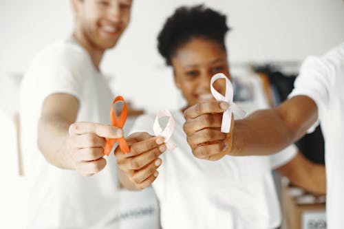 Free Group of People Holding Cancer Awareness Ribbons Stock Photo